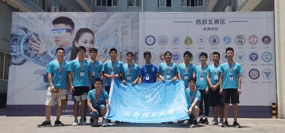 A group of people posing for a photo in front of a bannerDescription automatically generated with medium confidence